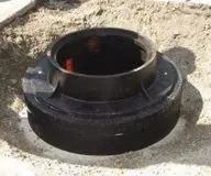 A black round equipment in the ground